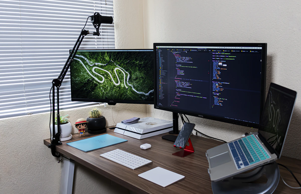 Computer monitor on a wooden desk displaying code